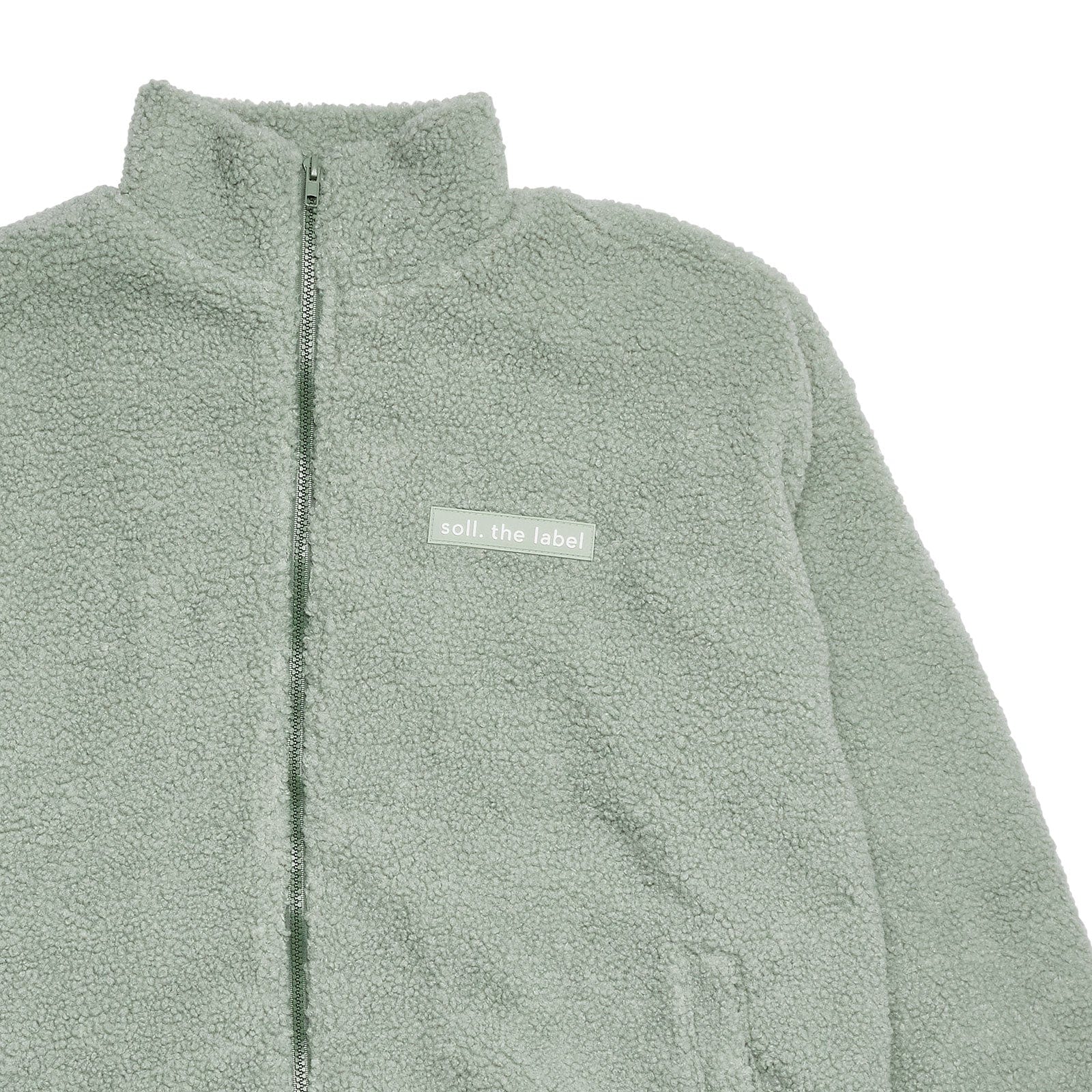 Adults Wooley Zip Jacket - Sage winter 23 soll. the label